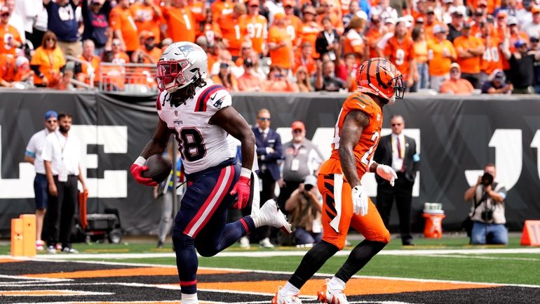 New England Patriots running back Rhamondre Stevenson (38) scores on...