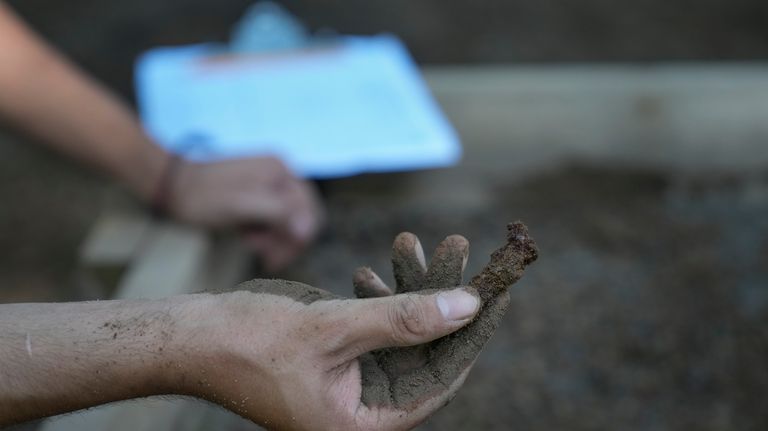 A student holds up what is likely a coffin nail...