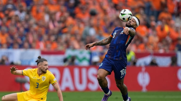 Memphis Depay of the Netherlands tries control the ball past...
