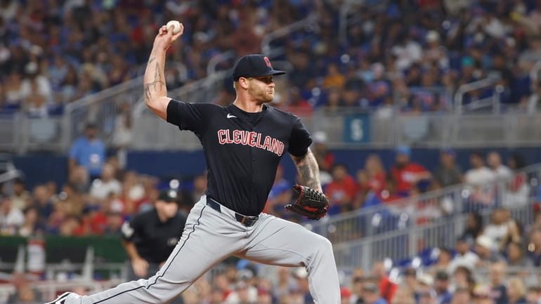 Cleveland Guardians pitcher Ben Lively throws to a Miami Marlins...