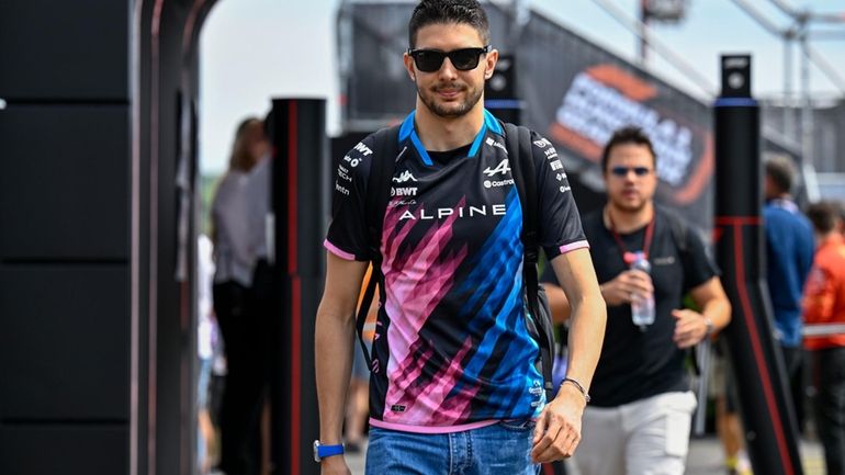 Alpine driver Esteban Ocon of France arrives in the paddock...