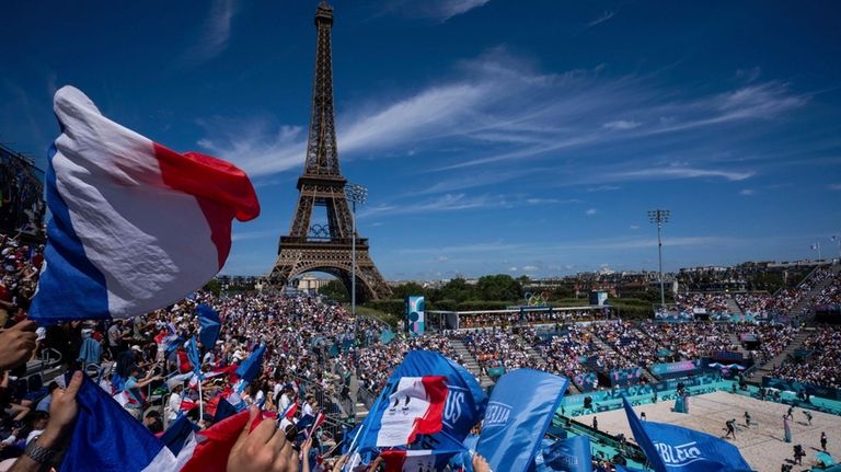 Supporters for France wave flags during the women's pool C...