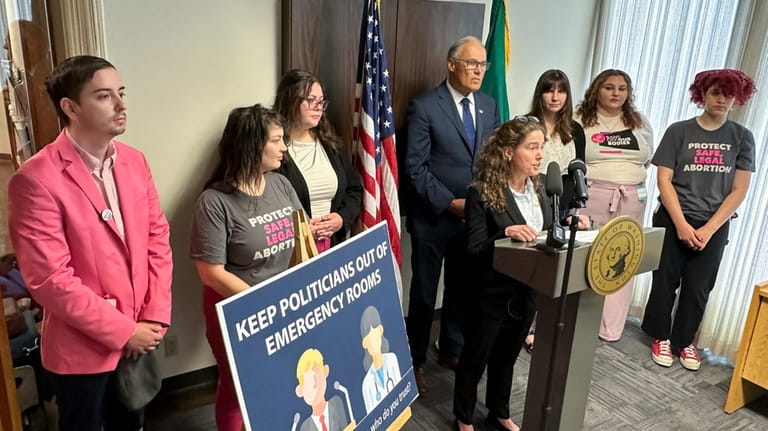Washington Gov. Jay Inslee, center rear, and abortion rights supporters...