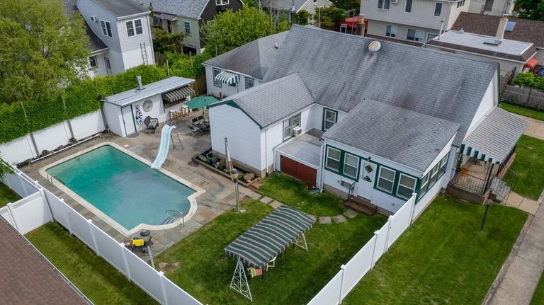 The backyard features a pool and cabana.