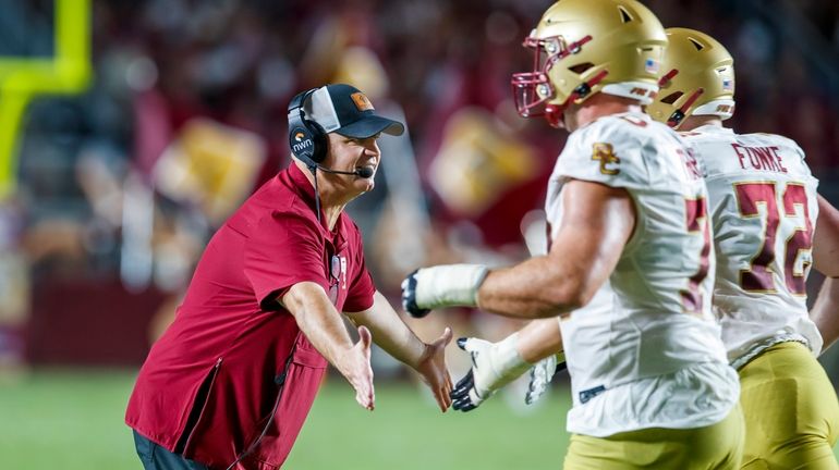 Boston College head coach Bill O'Brien congratulates players after his...