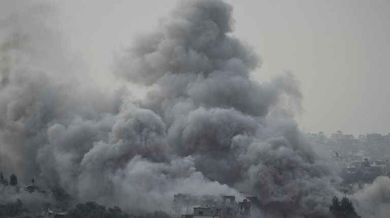 Smoke rises following an Israeli airstrike in the Gaza Strip,...