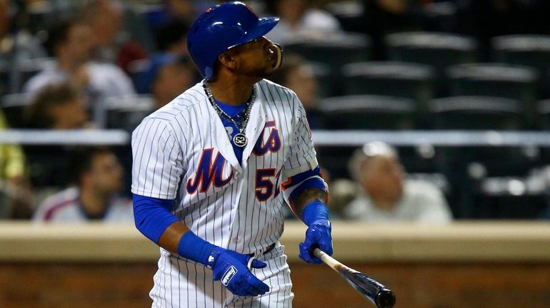 Yoenis Cespedes of the Mets follows through on his sixth-inning...