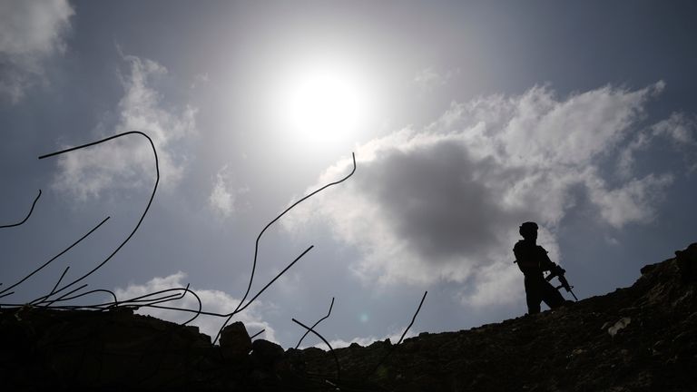 Israeli soldiers take up positions next to the Philadelphi Corridor...