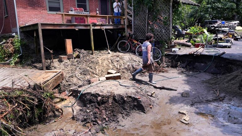 The washed out remains of a road in front of...