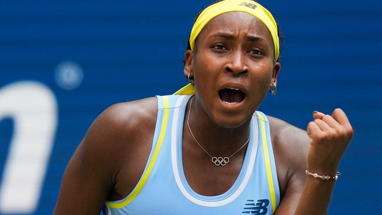 Coco Gauff, of the United States, reacts after scoring a...