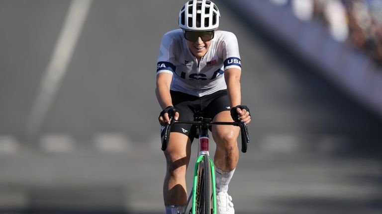 Kristen Faulkner, of the United States, crosses the finish line...