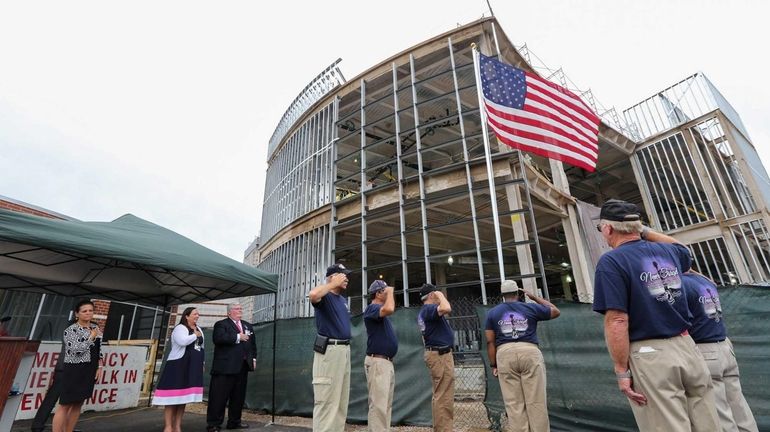 Members of VFW Post 8300 in East Patchogue raise a...