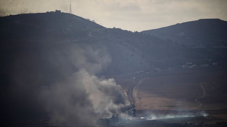 Smoke rises after an Israeli shelling on an area in...