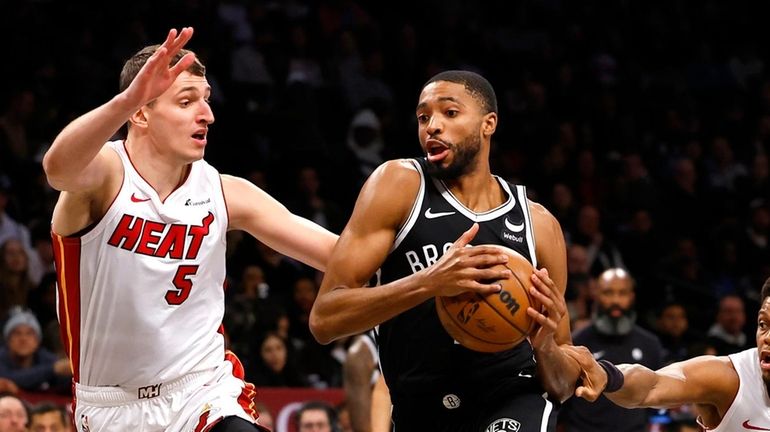 Nets forward Mikal Bridges (1) drives to the basket against...