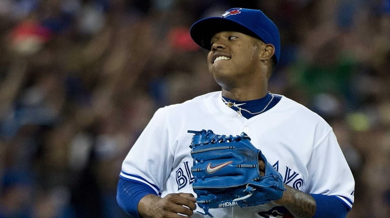 Toronto Blue Jays starting pitcher Marcus Stroman reacts after getting...