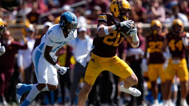 Minnesota defensive back Jack Henderson (20) runs with the football...