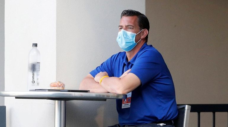 Mets general manager Brodie Van Wagenen looks on during summer...