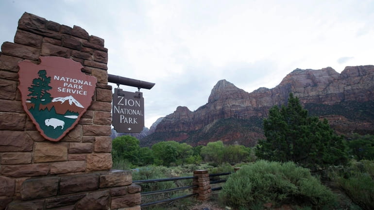 A sign hangs at Zion National Park on Tuesday, Sept....