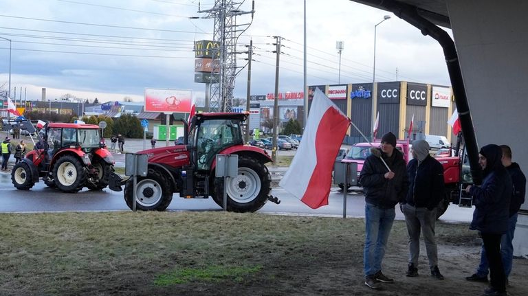 Polish farmers drive tractors in a convoy in Minsk Mazowiecki,...