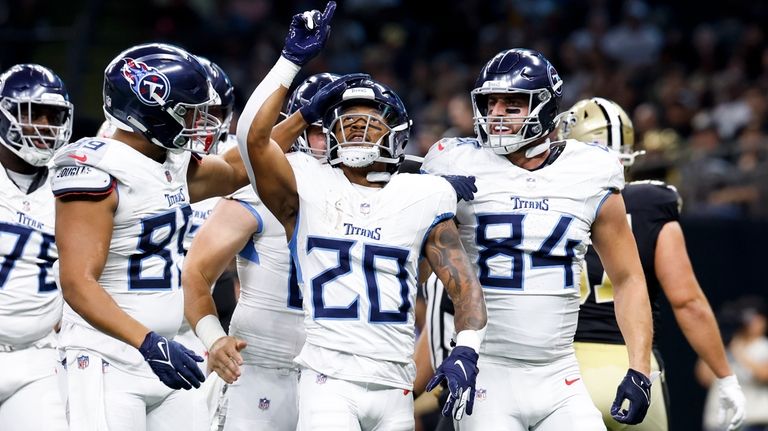 Tennessee Titans running back Tony Pollard celebrates after scoring against...