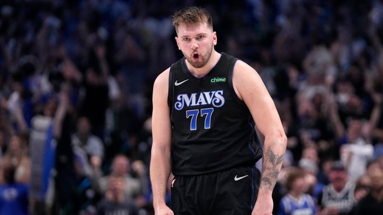 Dallas Mavericks' Luka Doncic celebrates after sinking a basket in...