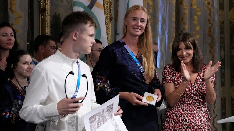 Paris mayor Anne Hidalgo, right, applauds after awarding Ukrainian athletes...