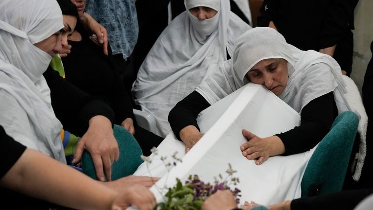 Members of the Druze minority mourn during the funeral of...