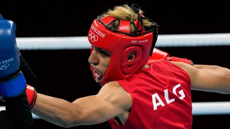 Imane Khelif, of Algeria, right, delivers a punch to Mariem...