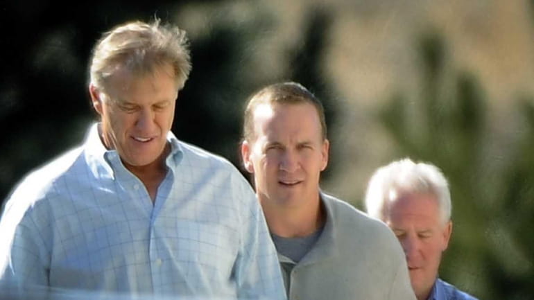 NFL football quarterback Peyton Manning, left, takes a tour with...
