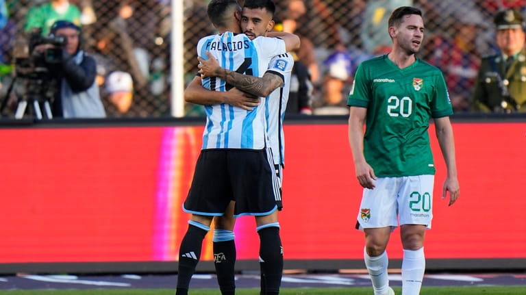 Argentina's Nicolas Gonzales embraces teammate Exequiel Palacios after scoring his...