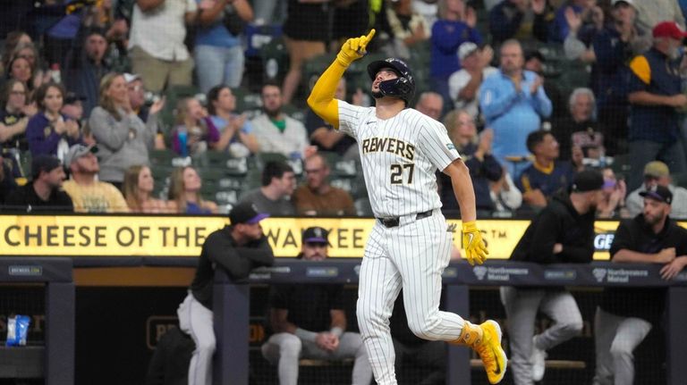 Milwaukee Brewers' Willy Adames (27) celebrates hitting a home run...