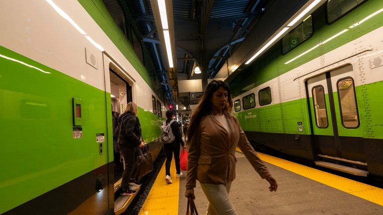 Commuters arrive at Union Station on a GO Train as...