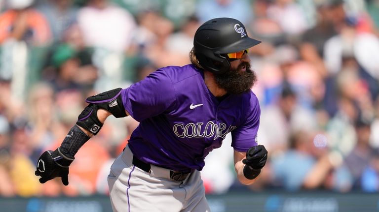 Colorado Rockies' Charlie Blackmon runs out a one-run single against...