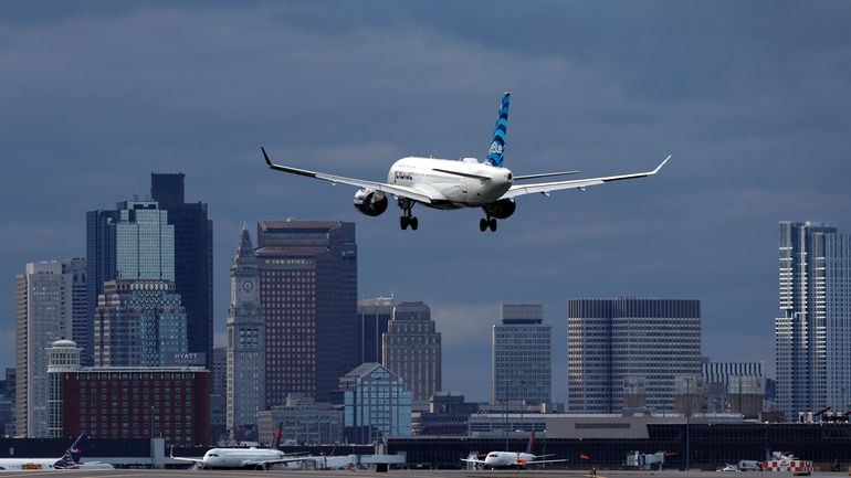 A JetBlue plane lands at Logan International Airport, Jan. 26,...