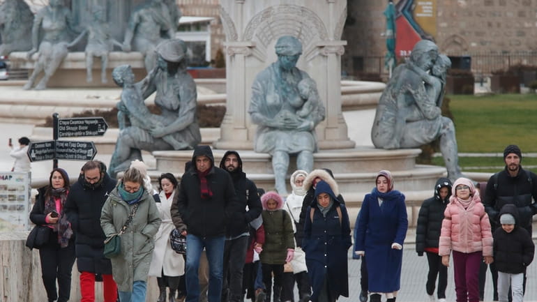 People walk through downtown Skopje, North Macedonia, on Sunday, Jan....