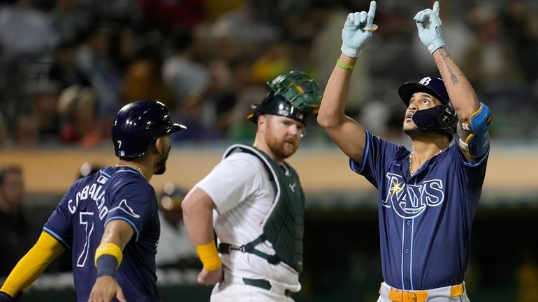 Tampa Bay Rays' Jose Siri, right, celebrates after hitting a...