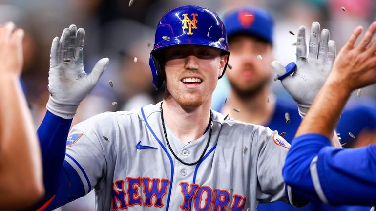 Brett Baty of the Mets celebrates with teammates after hitting a home...