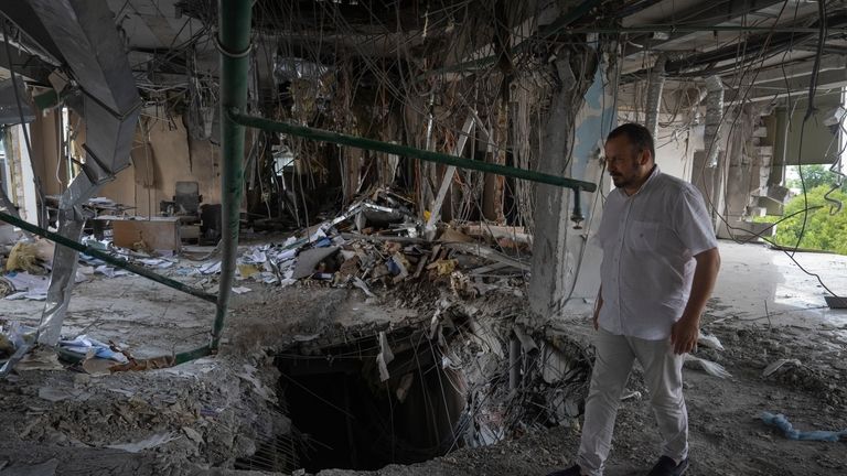 Alya Gali, a Gaza Strip-born doctor, looks at debris two...