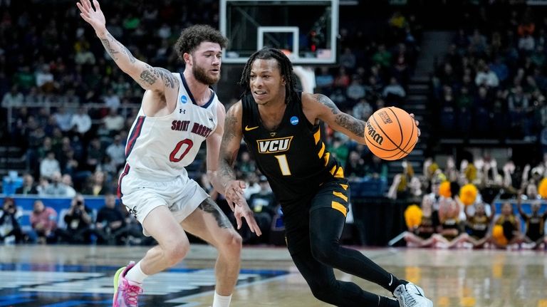 Virginia Commonwealth's Adrian Baldwin Jr. (1) drives against St. Mary's...