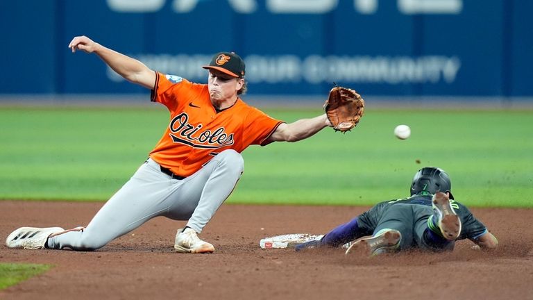 Tampa Bay Rays' Jose Caballero, right, steals second base as...