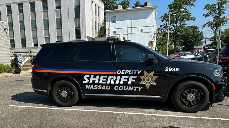 A Nassau County Deputy Sheriff's vehicle sits parked outside the...