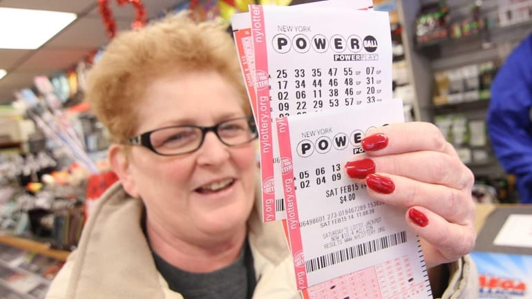 Agnes Vion, of Nesconset, holds up her Power Ball tickets...