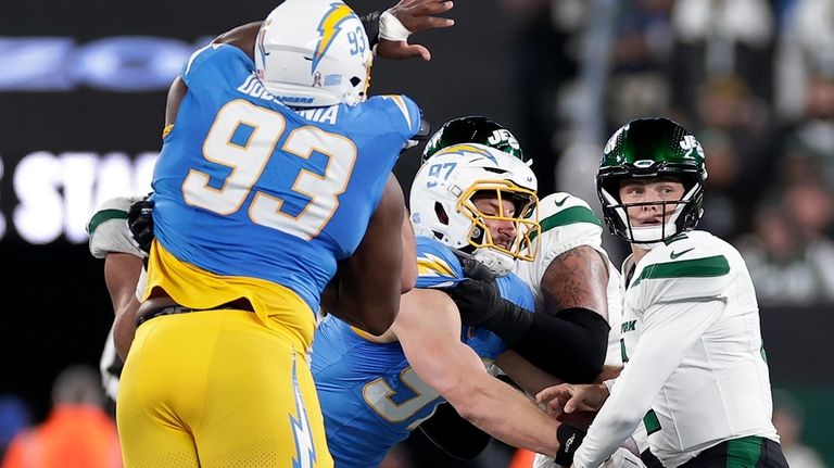 Los Angeles Chargers linebacker Joey Bosa (97) strips the ball...