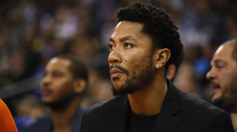 Derrick Rose of the New York Knicks sits on the...