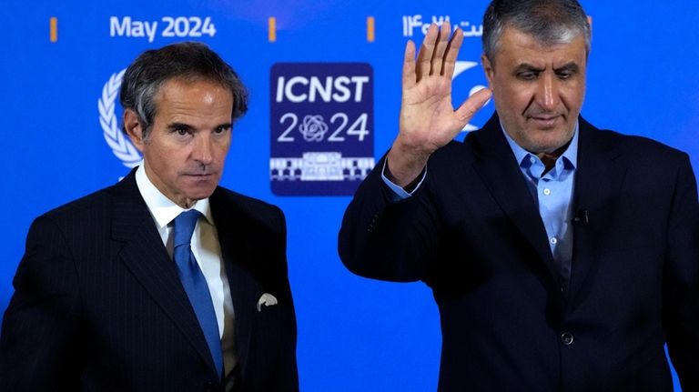 Head of Iran's atomic energy department Mohammad Eslami waves to...