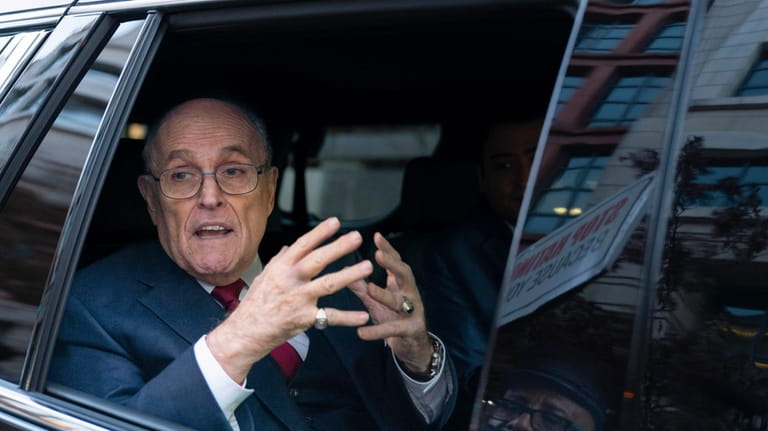 Rudy Giuliani talks to reporters as he leaves after his...