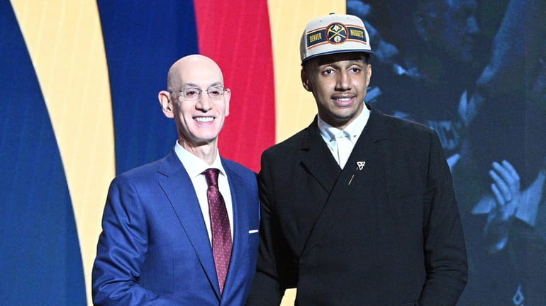 NBA Commissioner Adam Silver congratulates Ryan Dunn after being selected...
