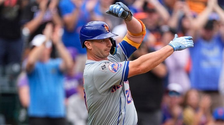 The Mets' Pete Alonso gestures to the bullpen as he...