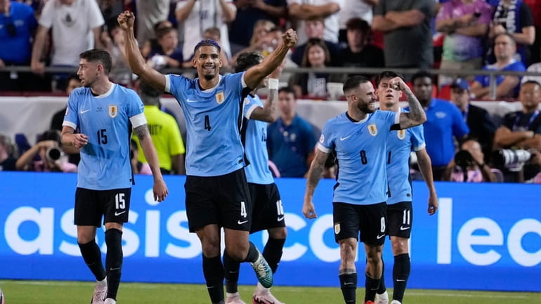Uruguay's Ronald Araujo (4) celebrates after a goal by Mathias...