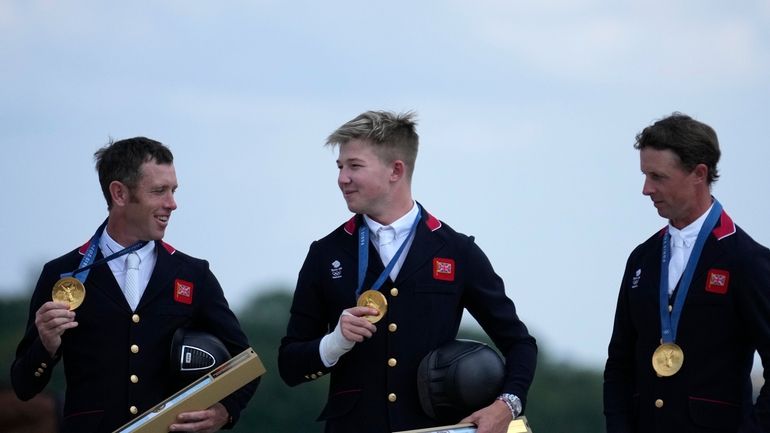 Britain's Scott Brash, left, Harry Charles, center, and Ben Maher...